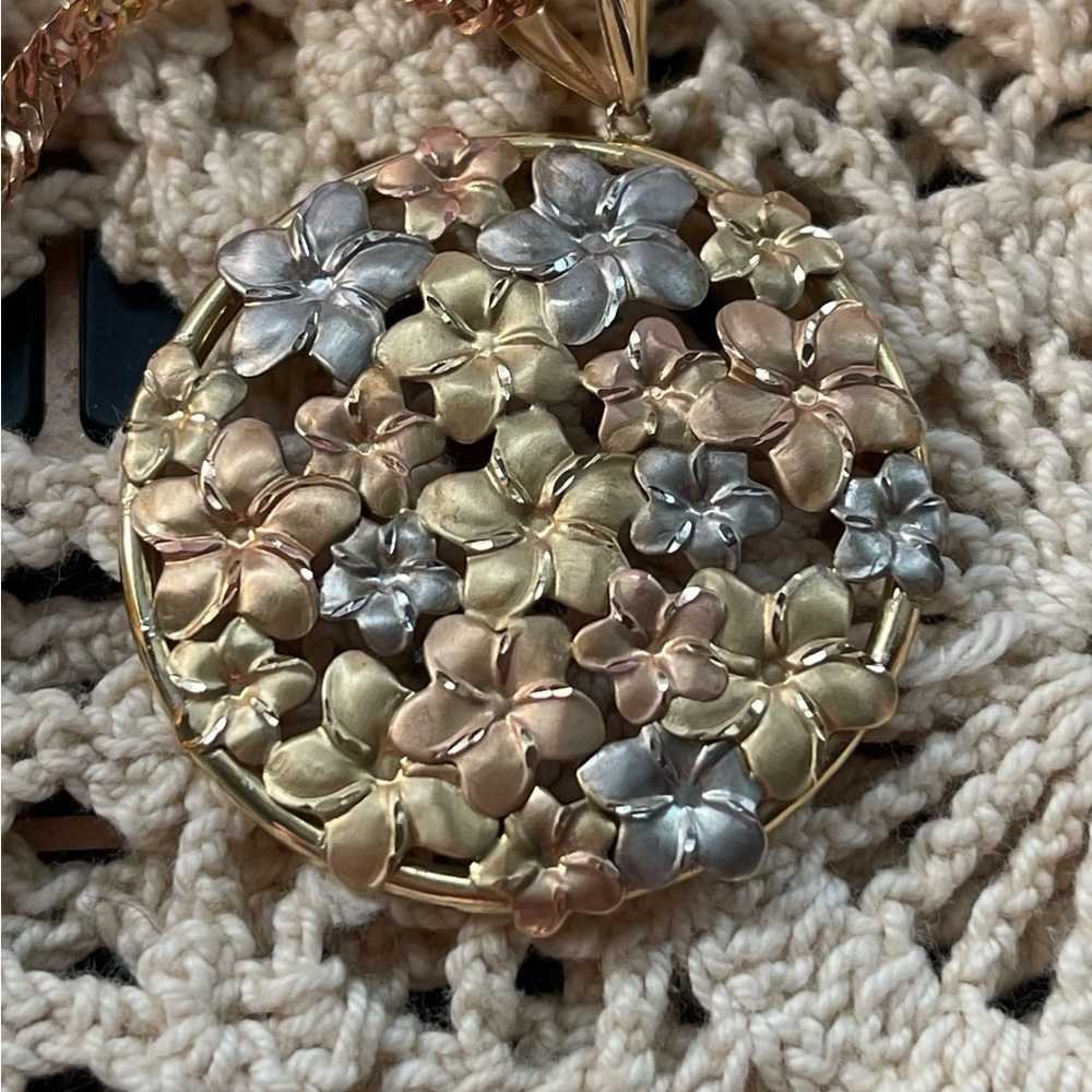 14K gold necklace with flowers on the pendant.